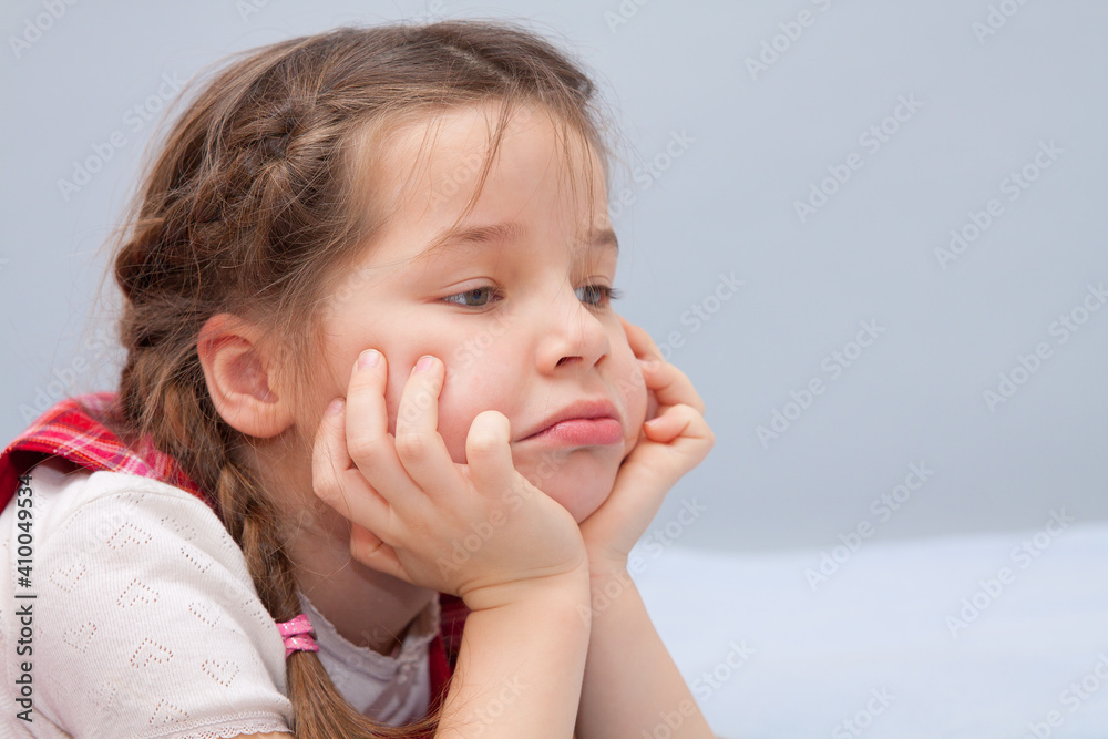 Portrait of a child with a pensive face. Portrait of a child with a pensive face.