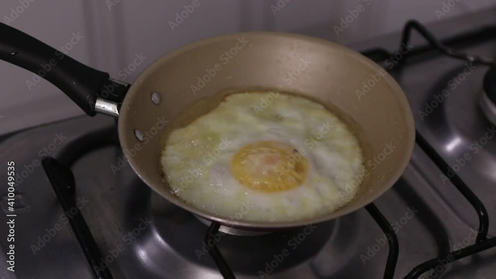 egg being fried in butter in skillet for breakfast egg being fried in butter in skillet for breakfast
