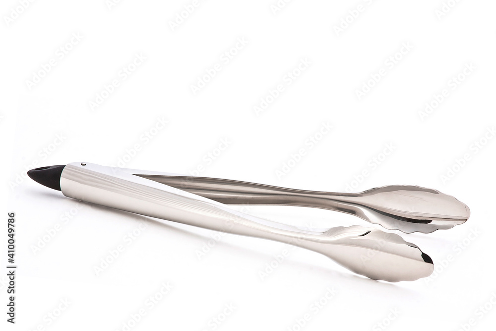 Metal kitchen tongs, stainless steel for serving, isolated on white background Metal kitchen tongs, stainless steel for serving, isolated on white background