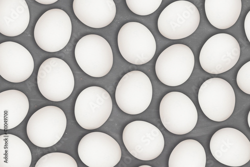 Pattern of white boiled easter eggs ready to be painted on a chalk board