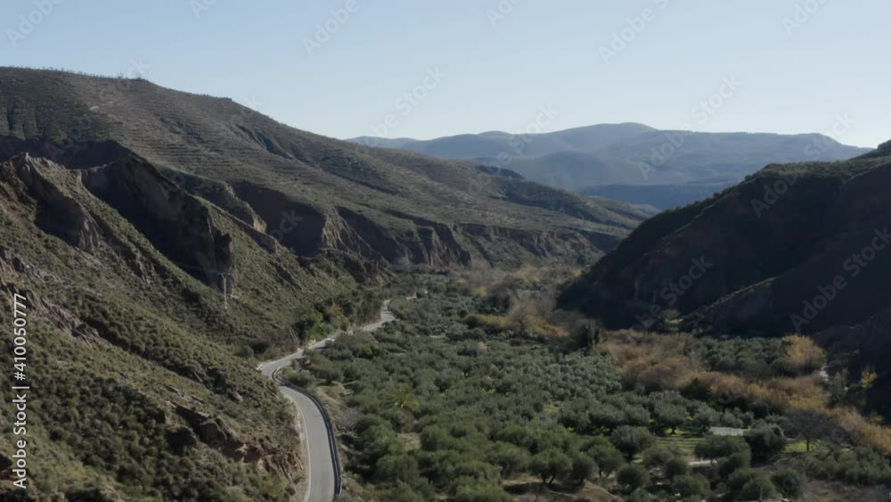 Stunning green mountain valley with blue sky and a single white farm house. Stunning green mountain valley with blue sky and a single white farm house.