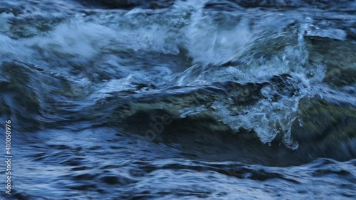 Detailed slow-mo footage of mesmirising rapids, with water flowing and bubbling in a stream in Northumberland, England