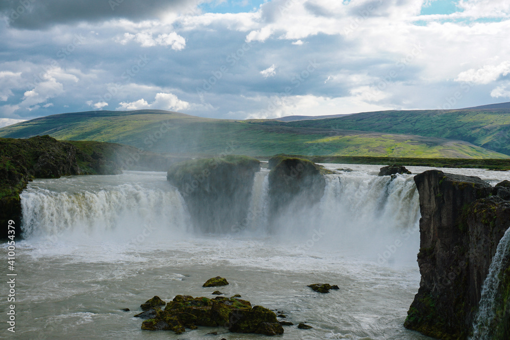 godafoss waterfall in summer cloudy weather, splashes of water rise up, there are beautiful clouds in the sky, nature of Iceland godafoss waterfall in summer cloudy weather, splashes of water rise up, there are beautiful clouds in the sky, nature of Iceland