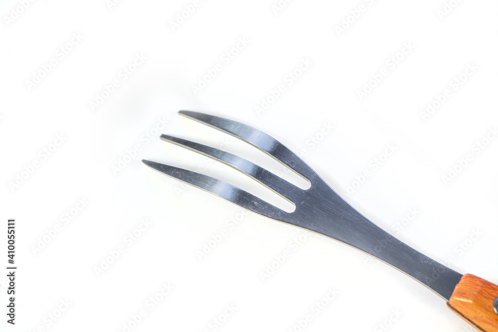 Fork with three prongs close up isolated on white background, photo for design Fork with three prongs close up isolated on white background, photo for design