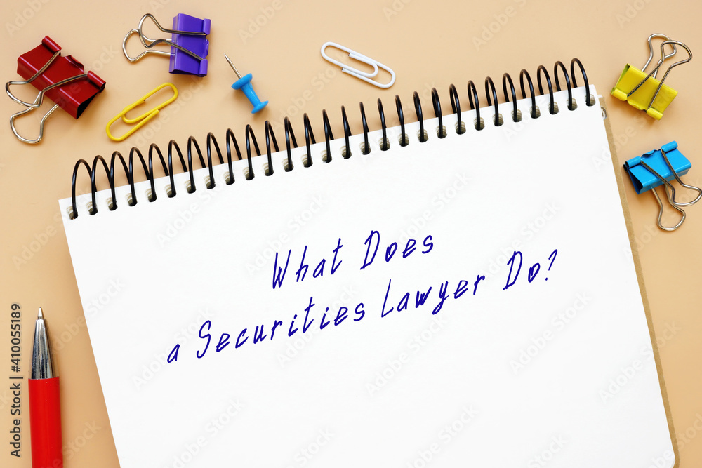 Legal concept meaning What Does a Securities Lawyer Do? with sign on the sheet. Legal concept meaning What Does a Securities Lawyer Do? with sign on the sheet.