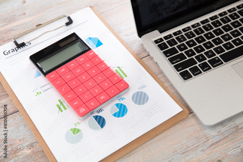 Folder and calculator by laptop Folder and calculator by laptop