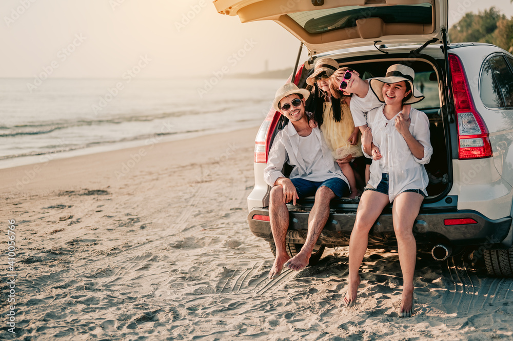 Happy asian family on a road trip in their car. Dad, mom and daughter ...