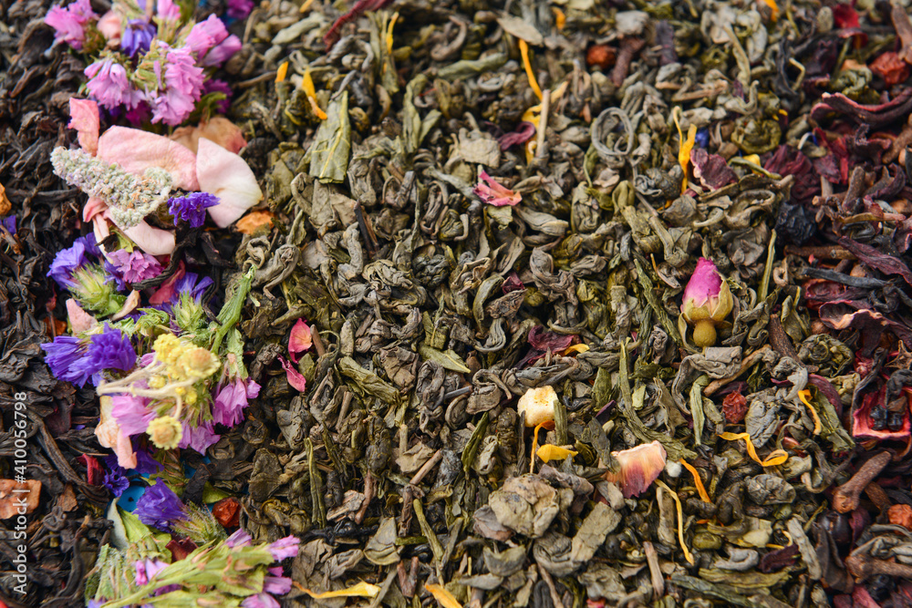 Dry tea leaves and flowers as background Dry tea leaves and flowers as background