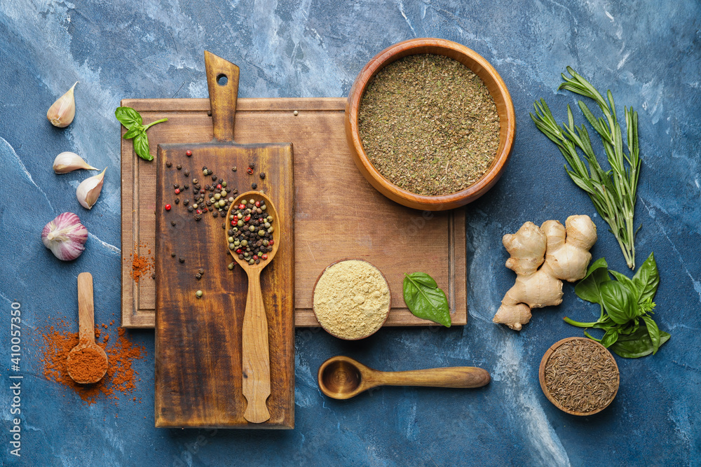 Composition with different spices and herbs on color background Composition with different spices and herbs on color background