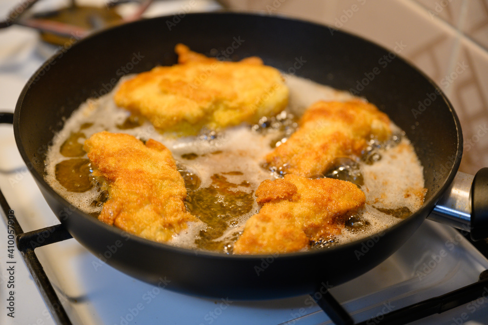 Close-up on frying cutlets in a pan.
