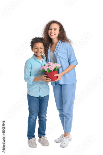 African-American boy and his mother with flowers on white background