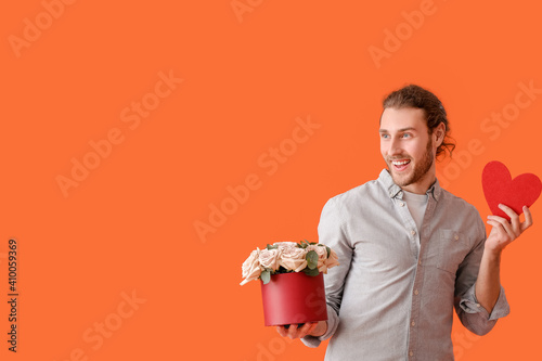 Young man with flowers and ...