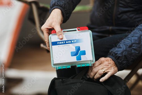 Retired woman travel with first aid kit