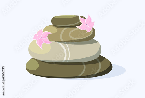 Spa massage stones with pink flowers on a blue background