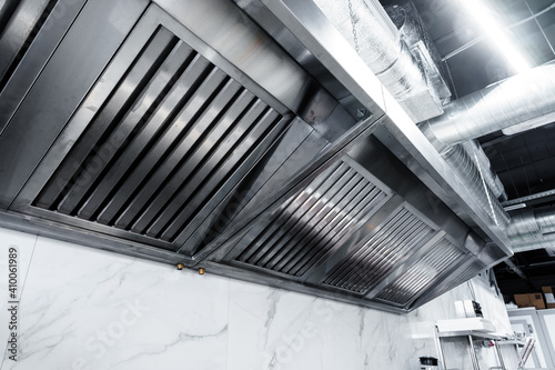 New clean stainless steel hood in professional kitchen