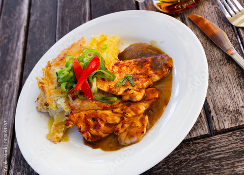 Sliced chicken with baked potatoes. Czech cuisine