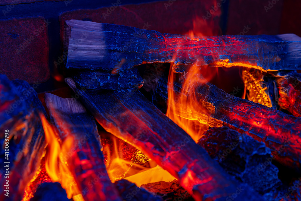 Close up of a fireplace with burning wood logs inside Close up of a fireplace with burning wood logs inside