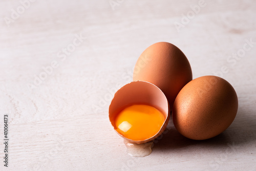 raw chicken eggs on a wooden background. Close-up view.