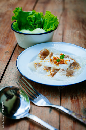 Selective focus of Thai steamed rice-skin dumplings or khao kriap pak maw is tow popular and unique Thai street food snacks ,
thai style dessert on wooden photo