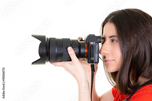 Pretty young brunette woman professional photographer with dslr camera in side view