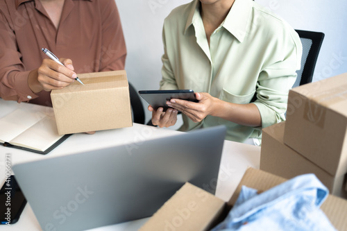 Wallpaper Mural Small business owner packing in the cardbox preparing parcel for delivery online selling sell Online on the Internet from home. Torontodigital.ca