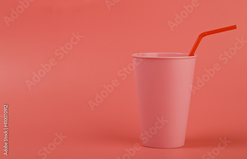 Pink glass, cup on a pink background close-up.