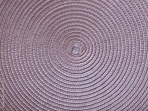 pink round braided pattern. close up of textile napkin