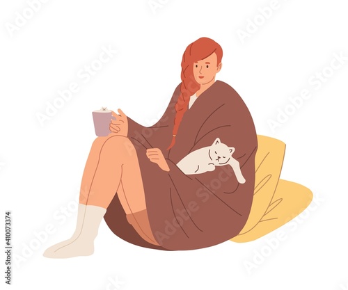 Young woman in warm socks and wrapped in cozy blanket holding tea cup. Female character relaxing with cat and drinking hot beverage at home. Flat vector illustration isolated on white background