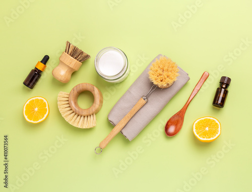 Eco friendly cleaning products and tools. Wooden bamboo brushes, baking soda, lemon, essential oils. Top view - Image