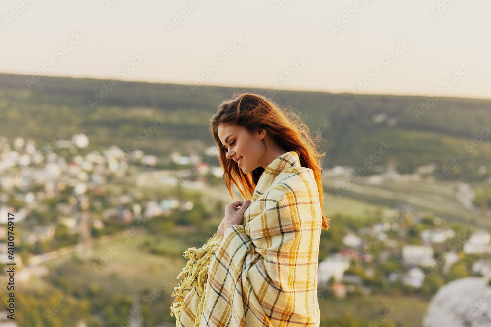 Woman with devoted shoulder look down side view and village in the background