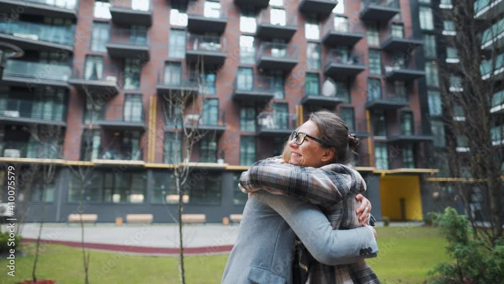 Two happy women hug each other when meeting after long separation. Slow motion Two happy women hug each other when meeting after long separation. Slow motion