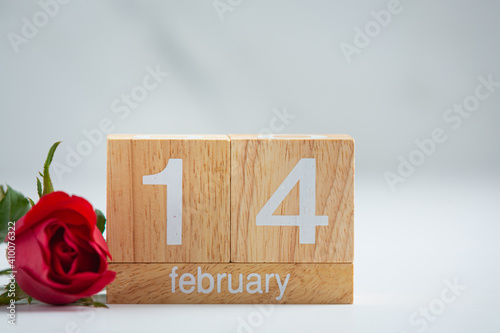 Wooden calendar on February 14 with roses