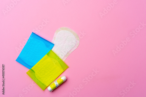 Female hygienic pad and tampons on pink background