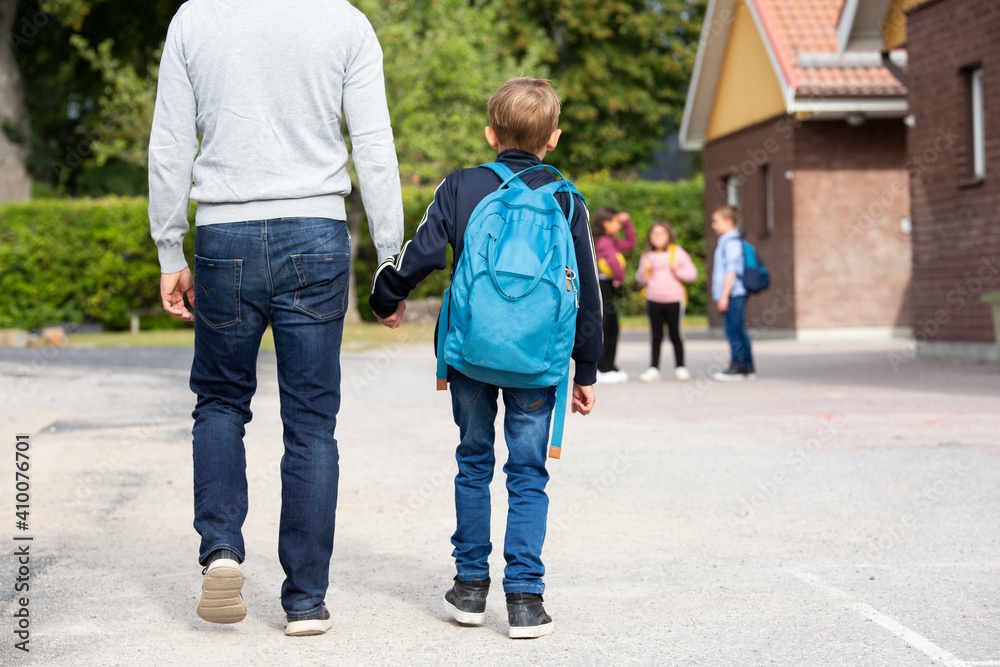 Father taking boy to school Father taking boy to school