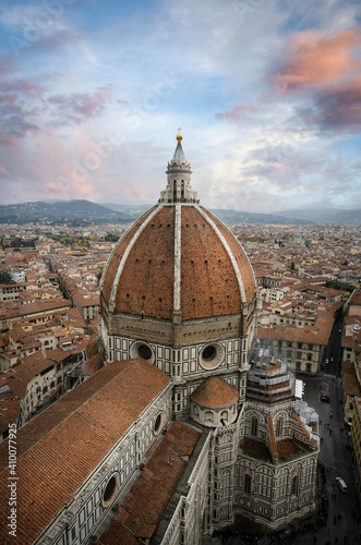 The Duomo in Florence, Italy, the Cathedral of Santa Maria del Fiore from the top with beautiful lights at cloudy day before sunset in Firenze