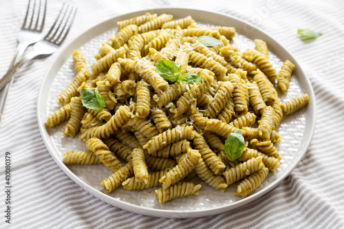 Homemade Pesto Twist Pasta on a plate, side view. Close-up.