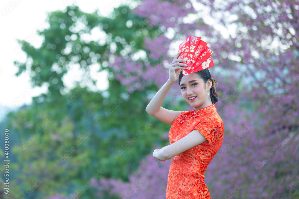 beautiful Asian woman show something and take red envelopes in chinese new year beautiful Asian woman show something and take red envelopes in chinese new year