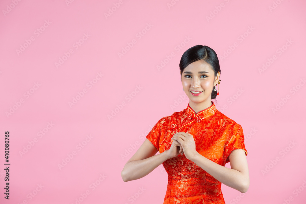 Asian beauty woman with gesture of congratulation in chinese new year Asian beauty woman with gesture of congratulation in chinese new year