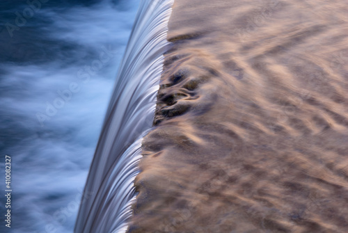 Creek with a cascade at sunset.  With a blurred stream of water.