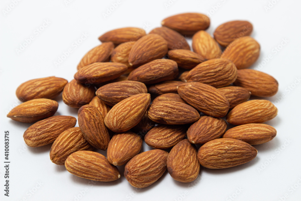 Almonds on a white background. Isolated almonds. Heap of roasted almonds Almonds on a white background. Isolated almonds. Heap of roasted almonds