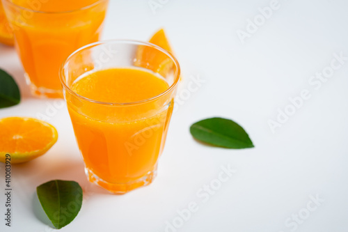 Fresh orange juice in the glass on marble background