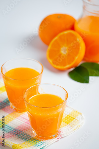 Fresh orange juice in the glass on marble background