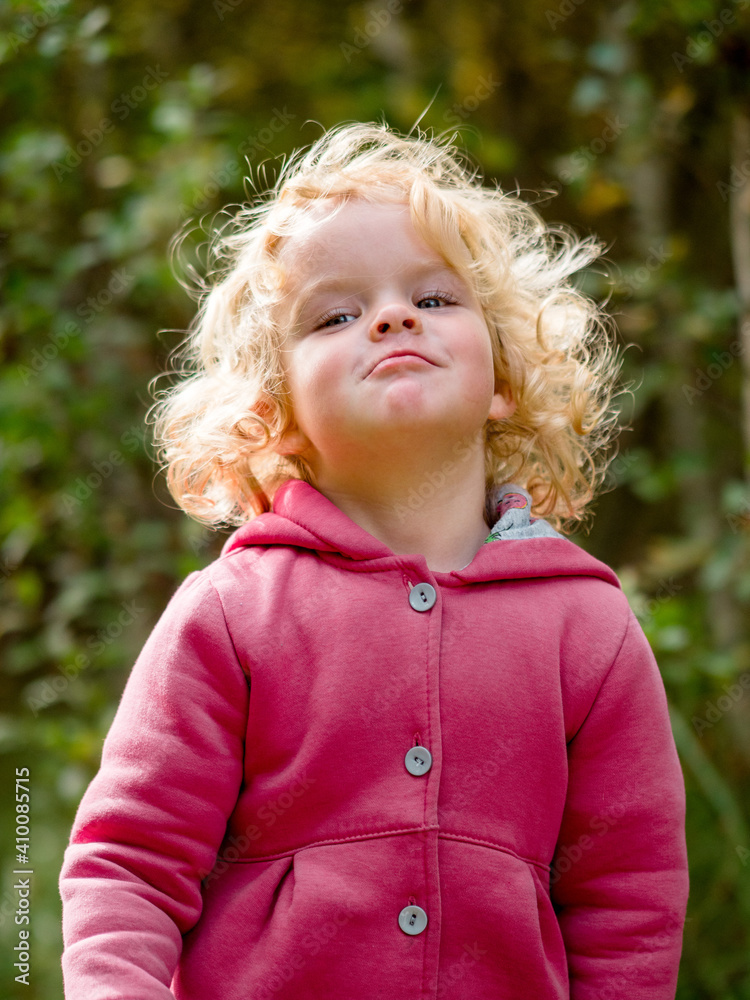 a child with curly hair walks merrily in the autumn forest a child with curly hair walks merrily in the autumn forest