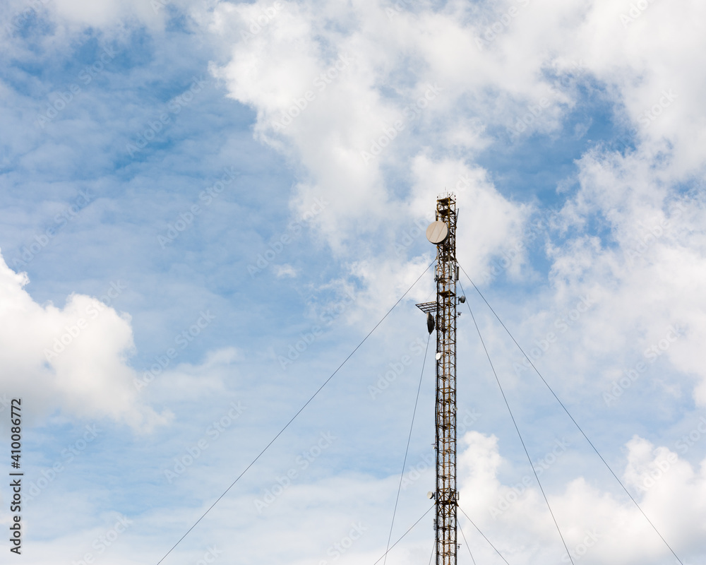 The metal tower with antennas for mobile communication and the Internet on the blue sky background. The metal tower with antennas for mobile communication and the Internet on the blue sky background.