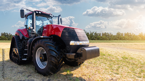 Red tractor on a agricultural field  