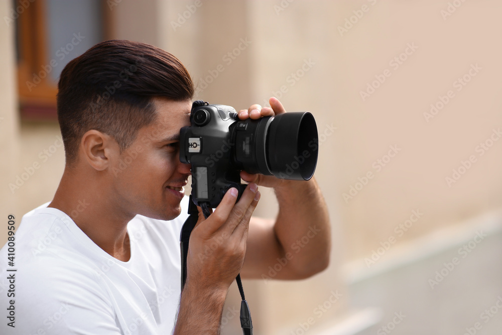 Photographer taking picture with professional camera on city street Photographer taking picture with professional camera on city street