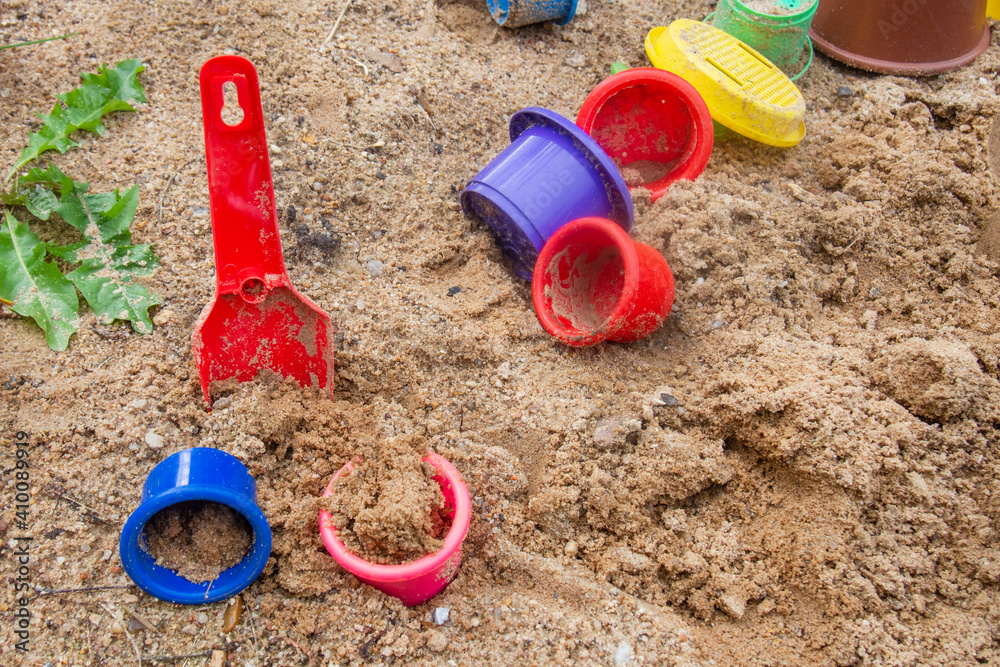 many children's toys in the sand many children's toys in the sand