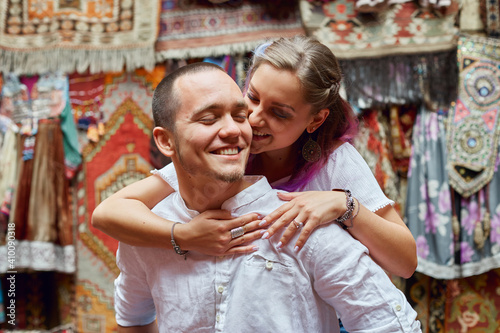 Photography Couple in love chooses a Turkish carpet at the market