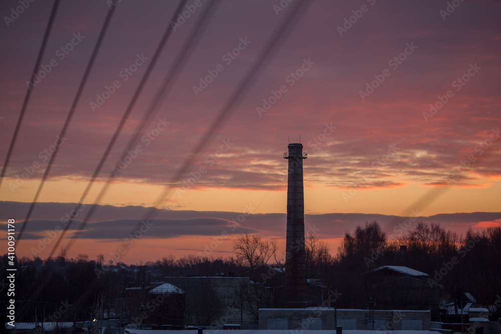 Chimney of the plant against the background of dawn. 