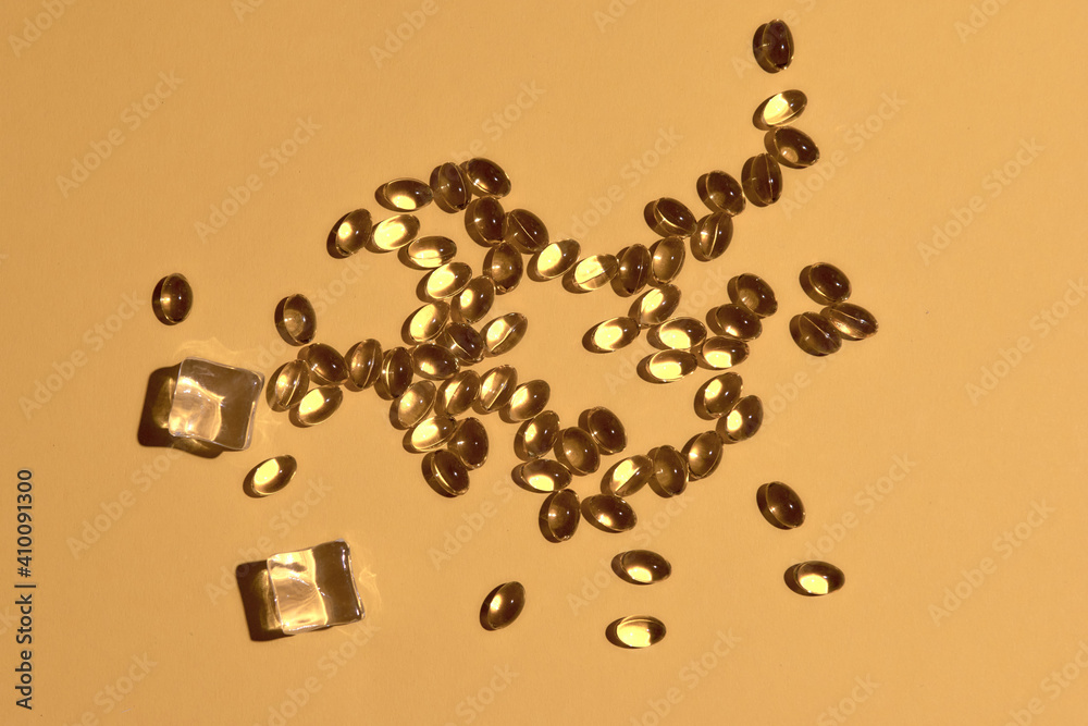 Many transparent pills Omega 3 or fish oil on a colorful background. Health supplements and medicines Many transparent pills Omega 3 or fish oil on a colorful background. Health supplements and medicines